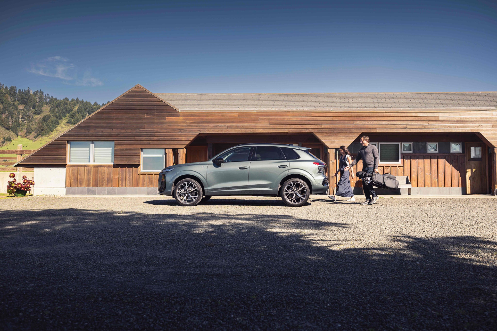 Right side profile view of an Audi Q3 parked.